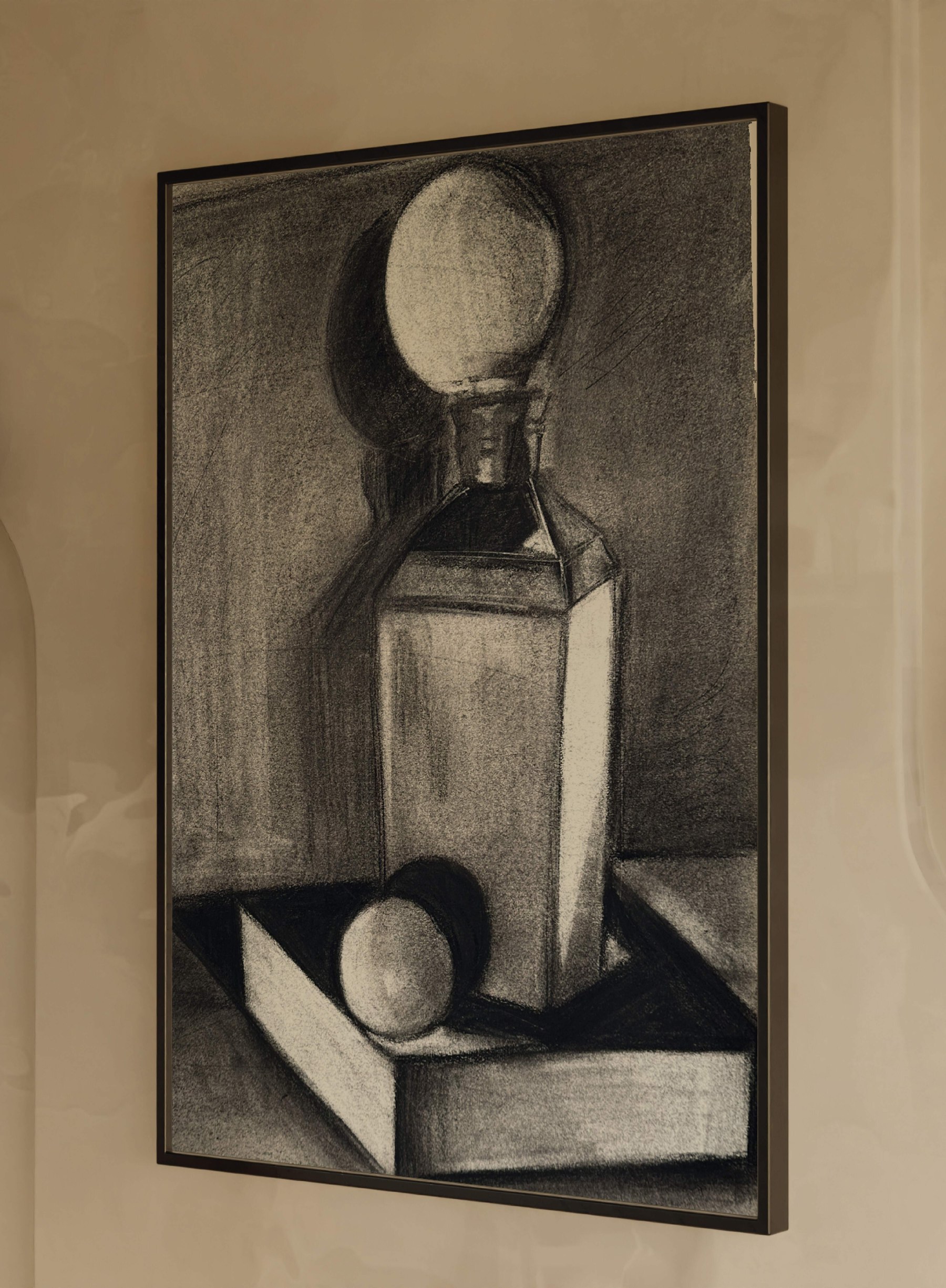 The decanter study in a slim black frame, hung on a warm plaster wall