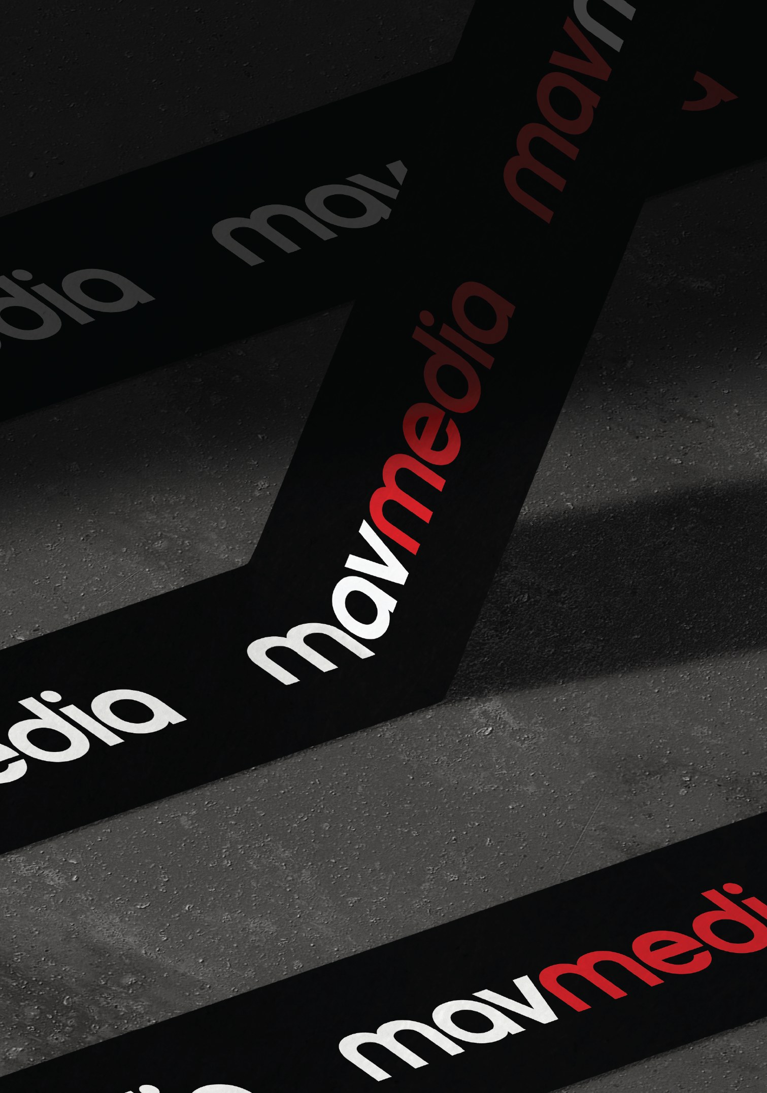 Mavmedia cards fanned across concrete, the wordmark repeating in red, white and black